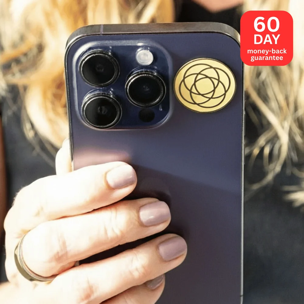 Gold Harmoni EMF protection sticker on a navy phone with 60-day money-back guarantee badge